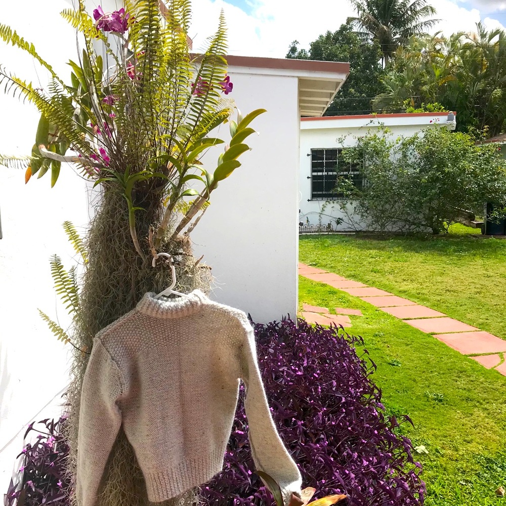 Hand knit grey wool warm sweater with flecks of blue and orange